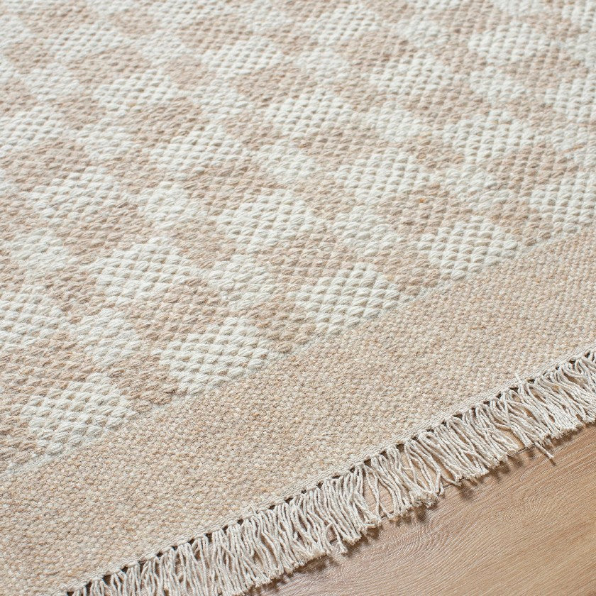 Clinten Solid and Border Tan Area Rug