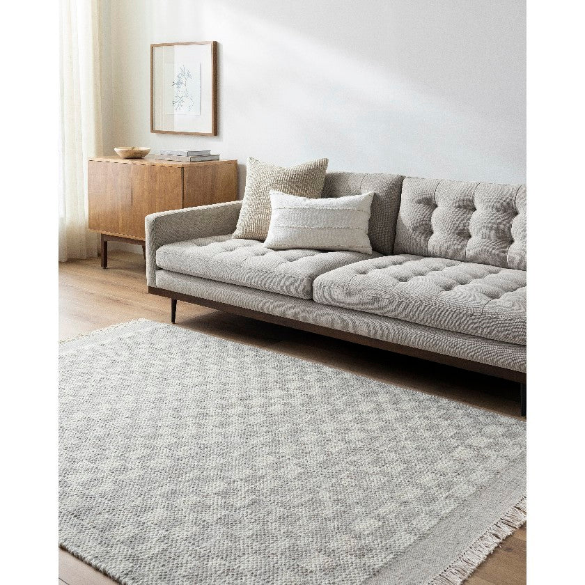 Clinten Solid and Border Ivory Area Rug