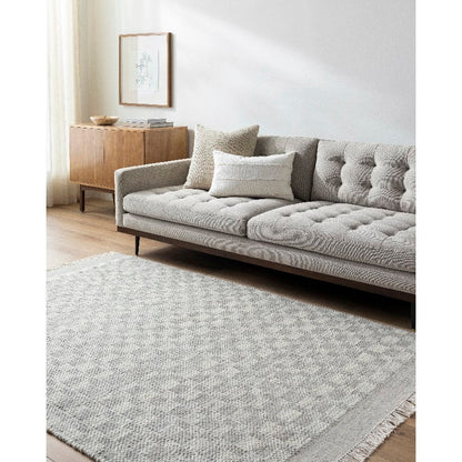 Clinten Solid and Border Ivory Area Rug