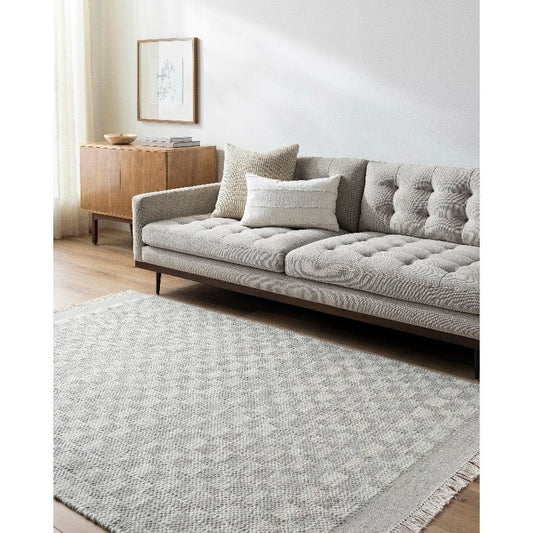 Clinten Solid and Border Ivory Area Rug