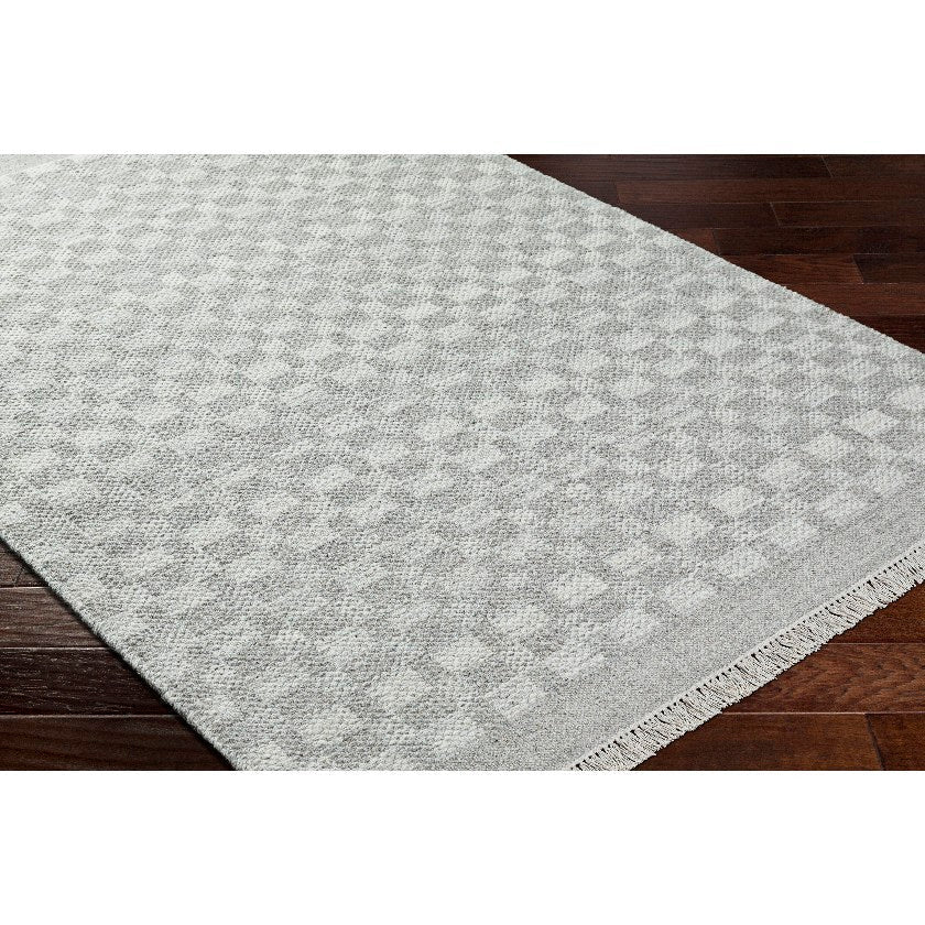 Clinten Solid and Border Ivory Area Rug