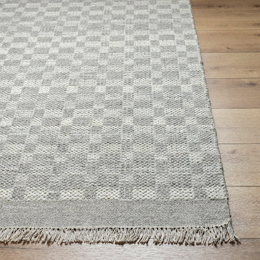 Clinten Solid and Border Ivory Area Rug