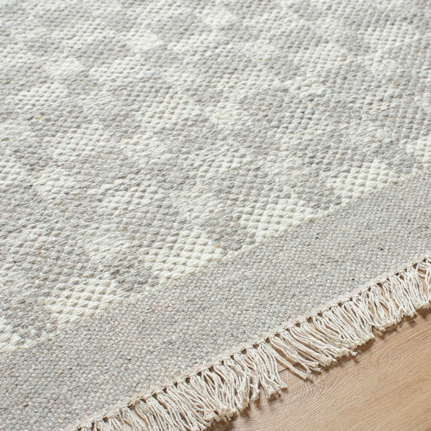 Clinten Solid and Border Ivory Area Rug