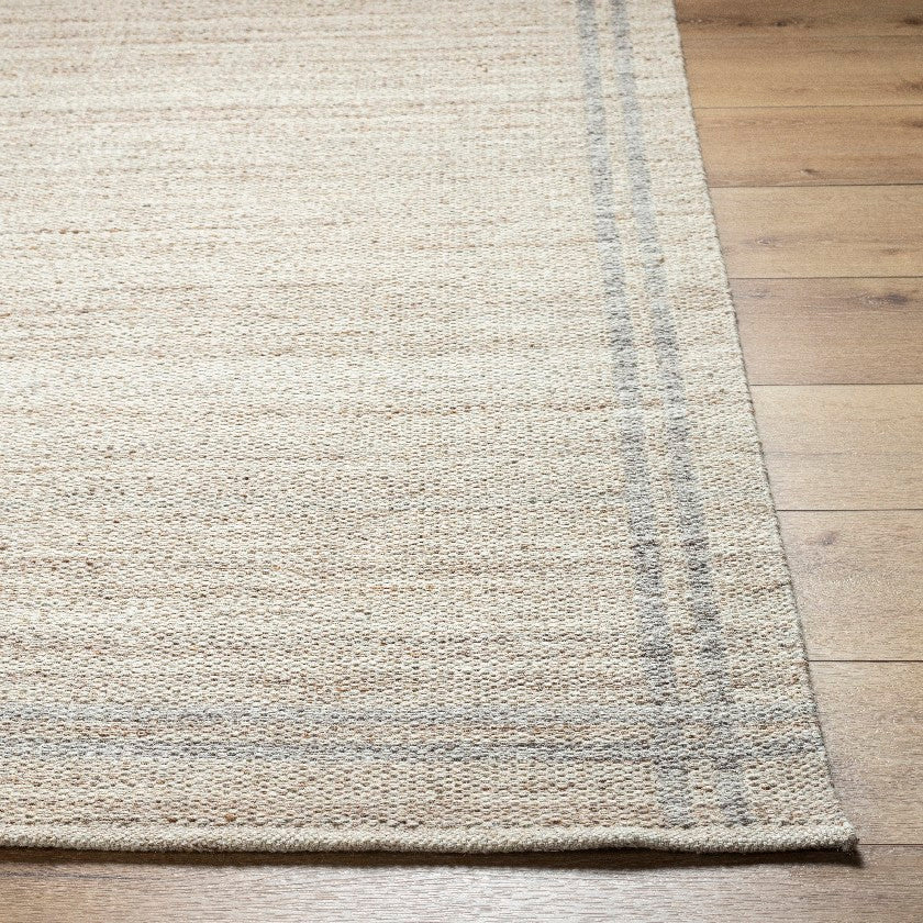 Janmichael Solid and Border Tan Area Rug